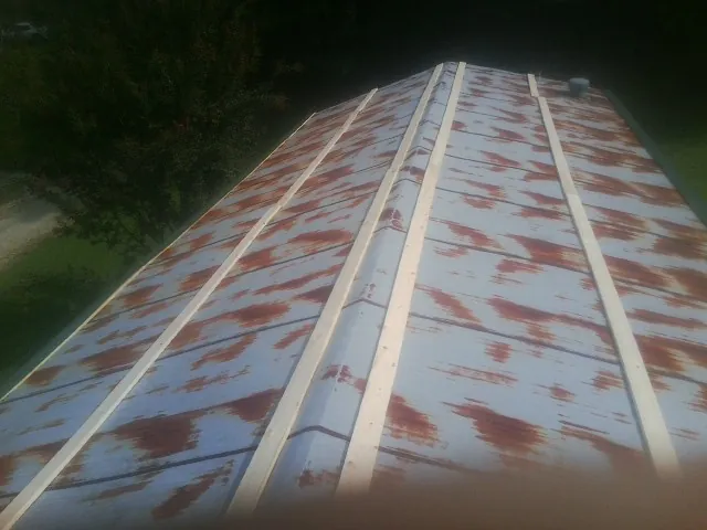 Rusted metal roof panels with new wood purlins before replacement — Storm Damage Roof Repair in Mc Caysville by Roofing Brothers