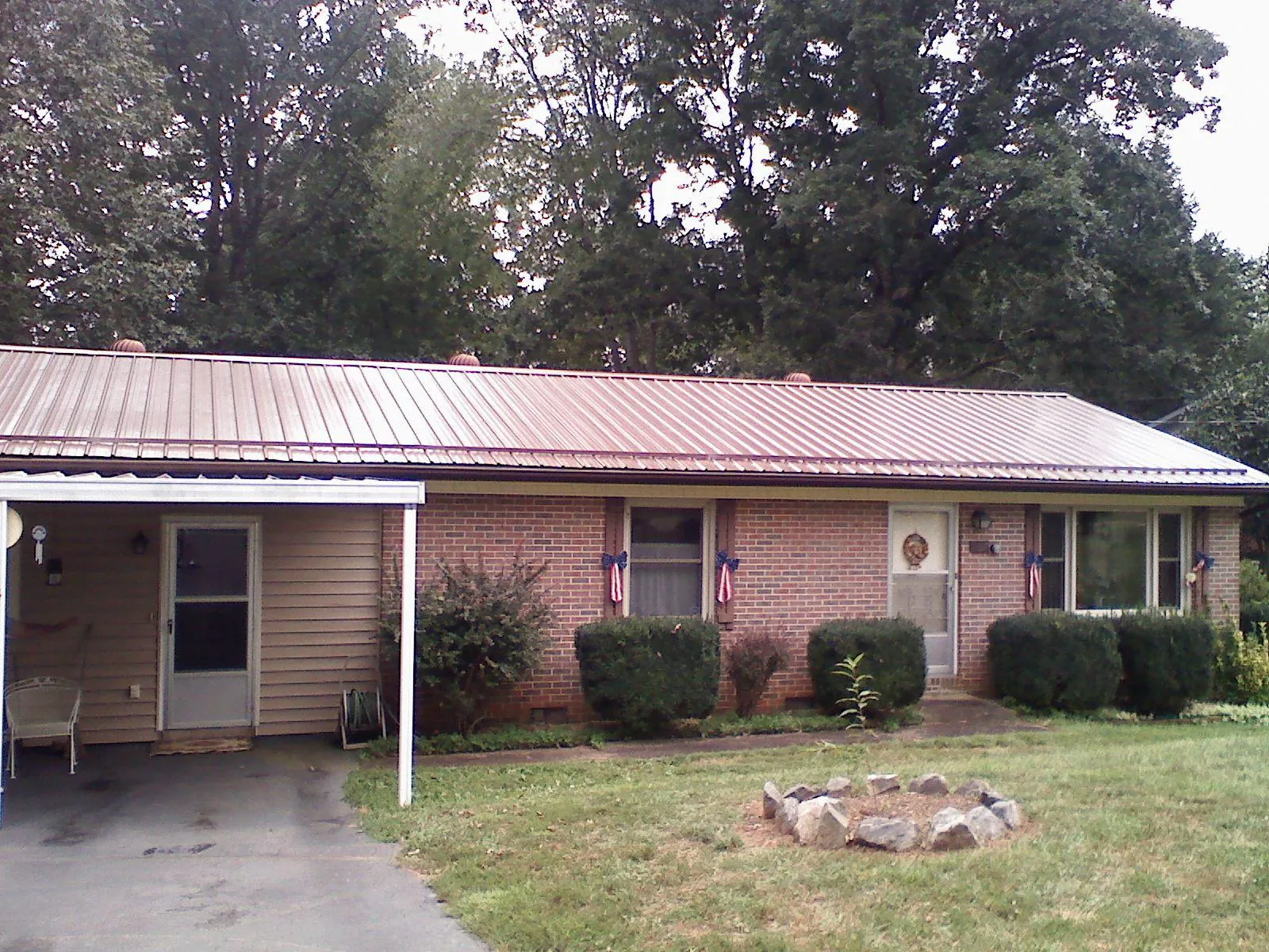 Bronze metal roof and carport on a brick ranch home — Roof Repair work by our crew in Mc Caysville